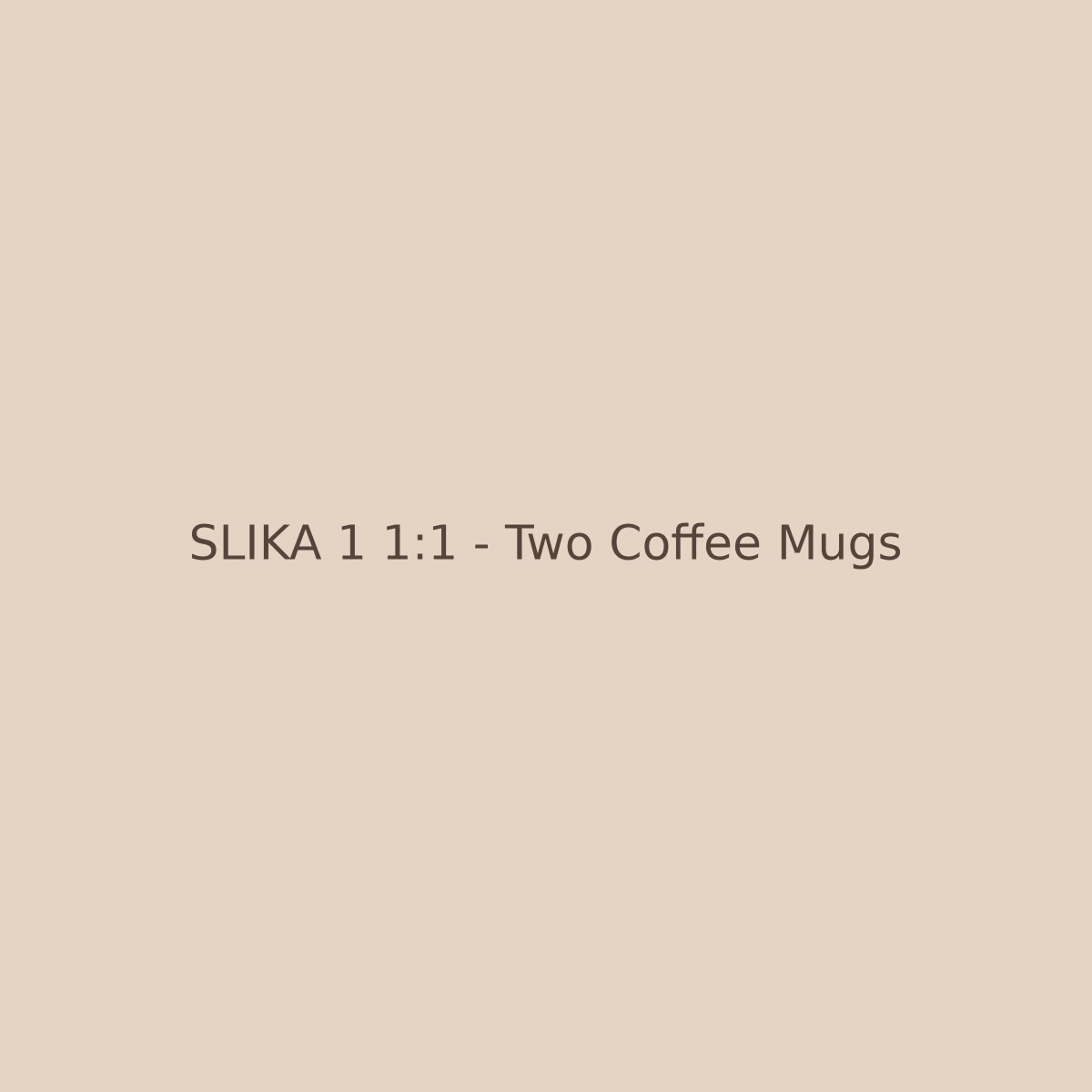 Top down view of two ceramic coffee mugs resting on a wooden table