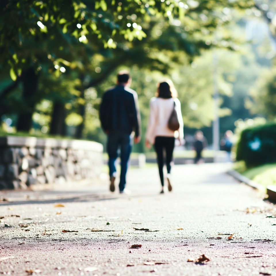 Two friends having an engaging conversation while walking down a park path